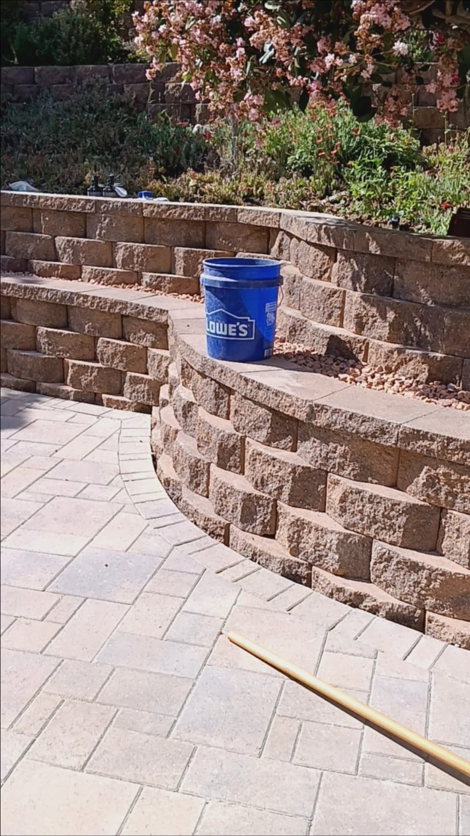 Curved tan retaining wall with paver patio